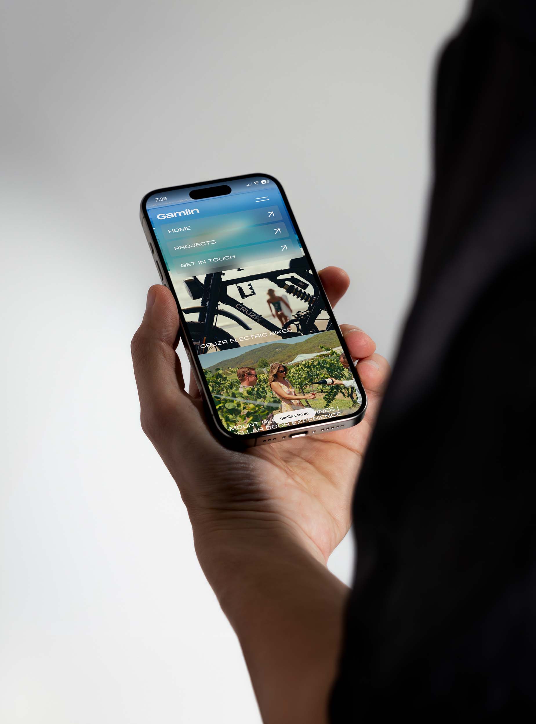 Gamlin website shown on a mobile phone held in hand